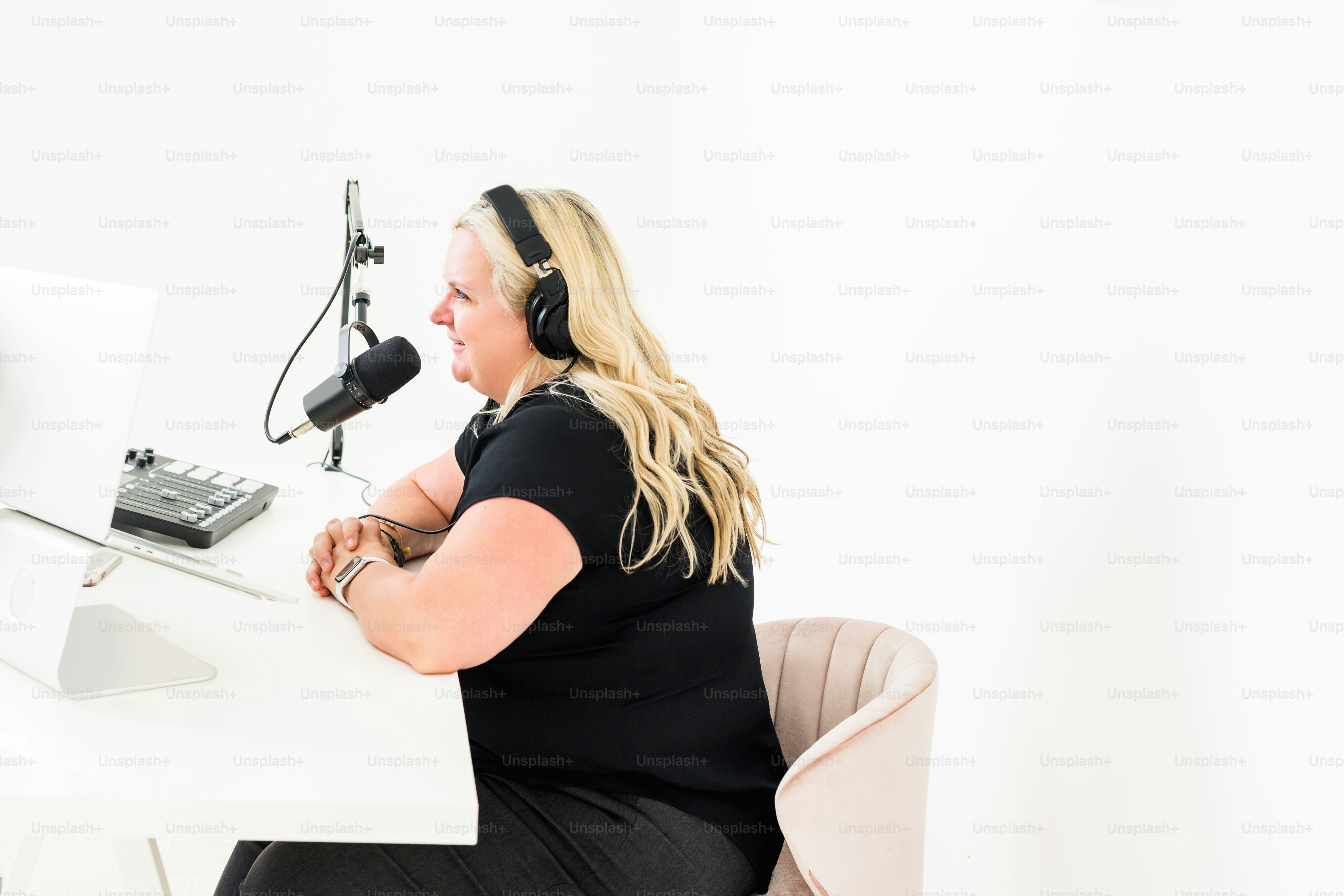 a woman sitting at a desk with headphones on