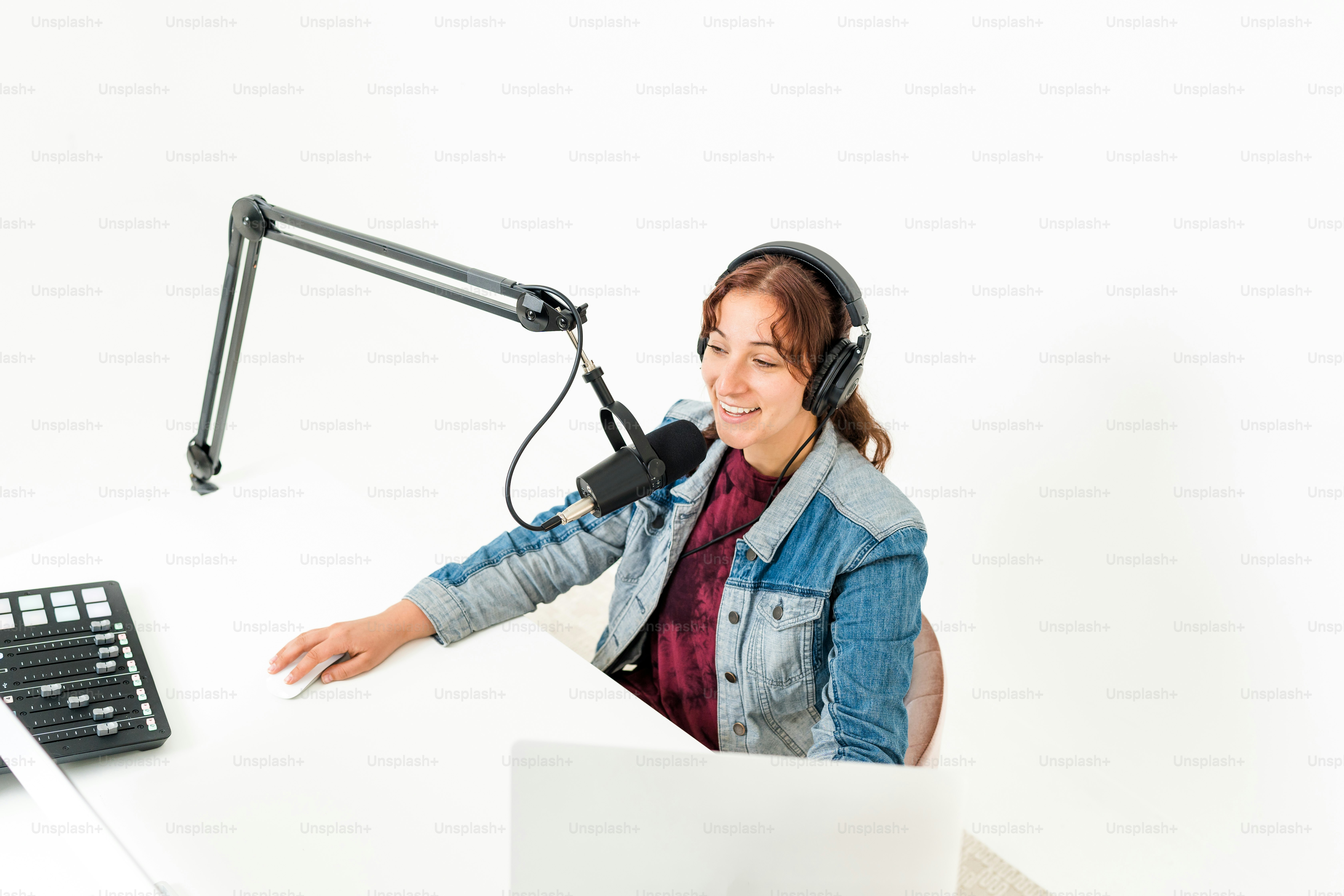 a woman wearing headphones sitting in front of a computer