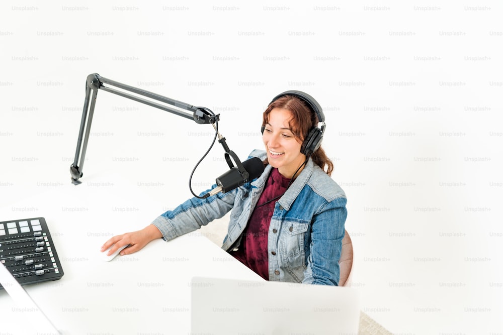 a woman wearing headphones sitting in front of a computer