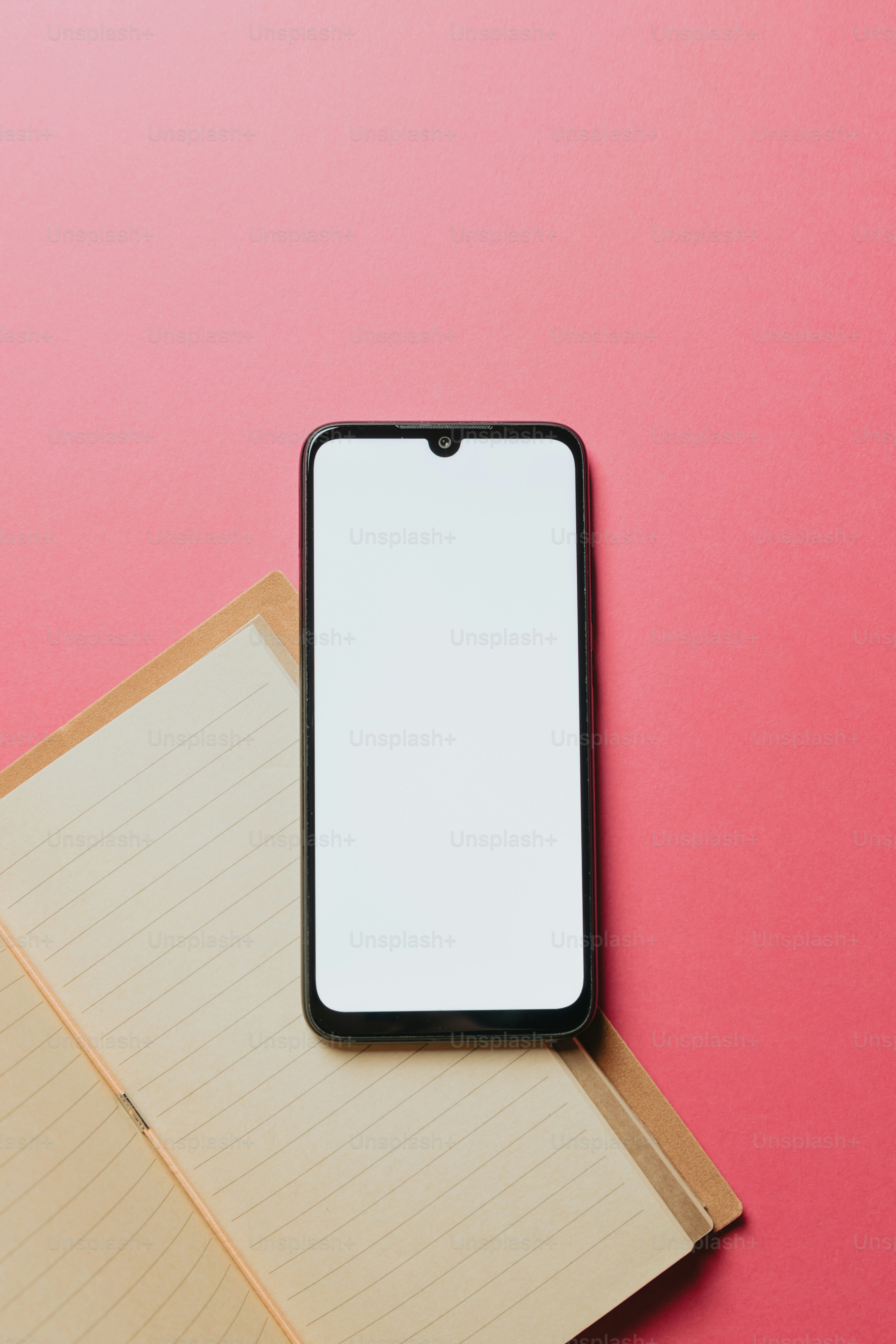a cell phone sitting on top of a notebook
