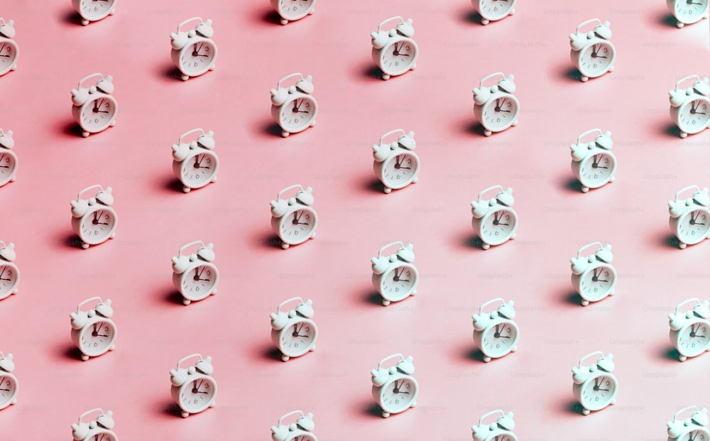 a pink background with a lot of small white objects