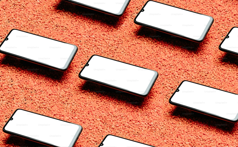 a close up of a group of cell phones on a red surface