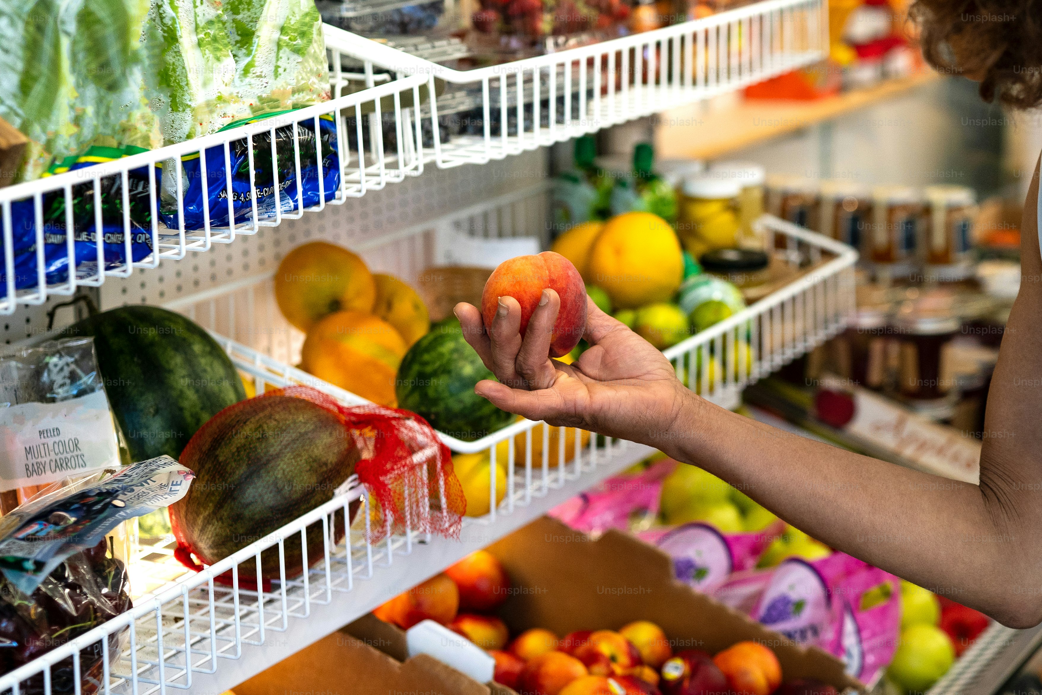 a woman holding a piece of fruit in a store