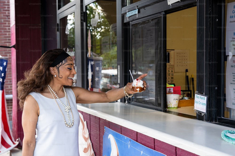 a woman is pointing at something in a window