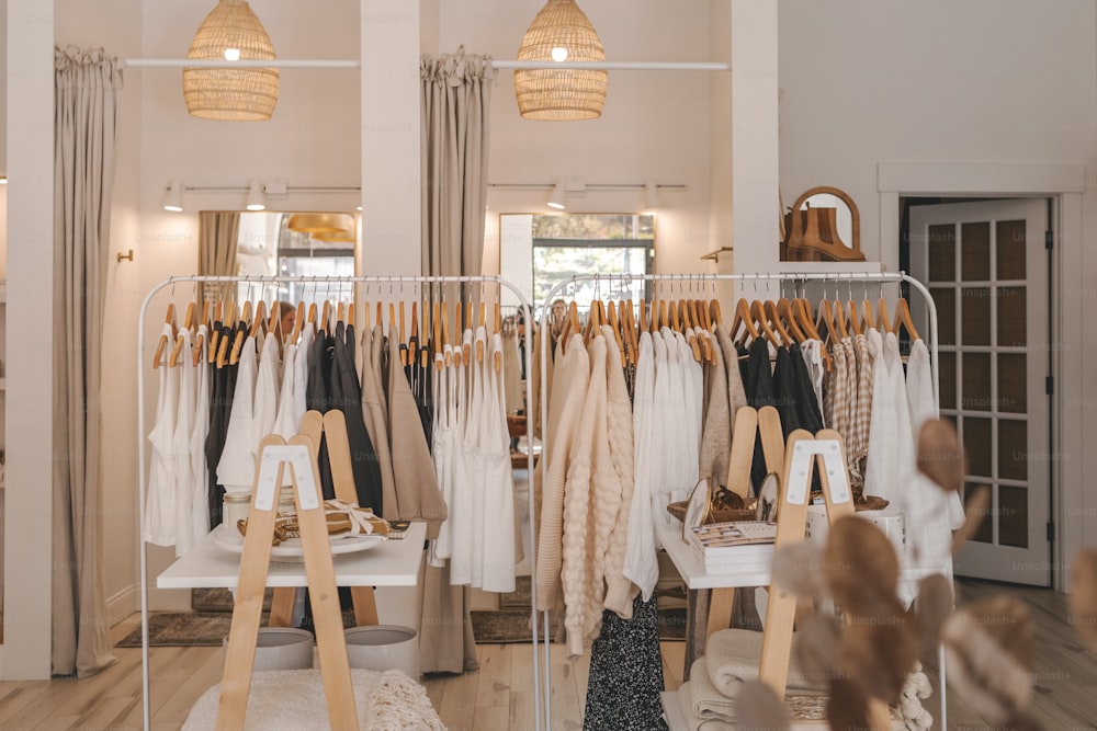 A clothing rack with clothes hanging on it photo Shop Image on Unsplash A clothing rack with clothes hanging on it photo Shop Image on Unsplash