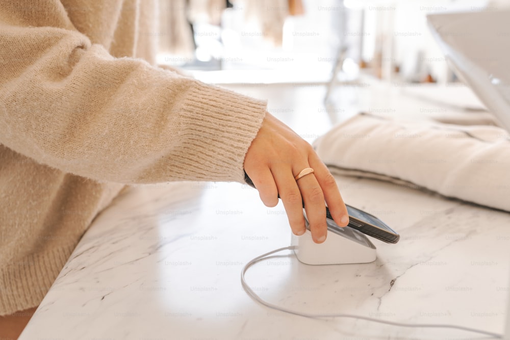 a woman using a cell phone on a table