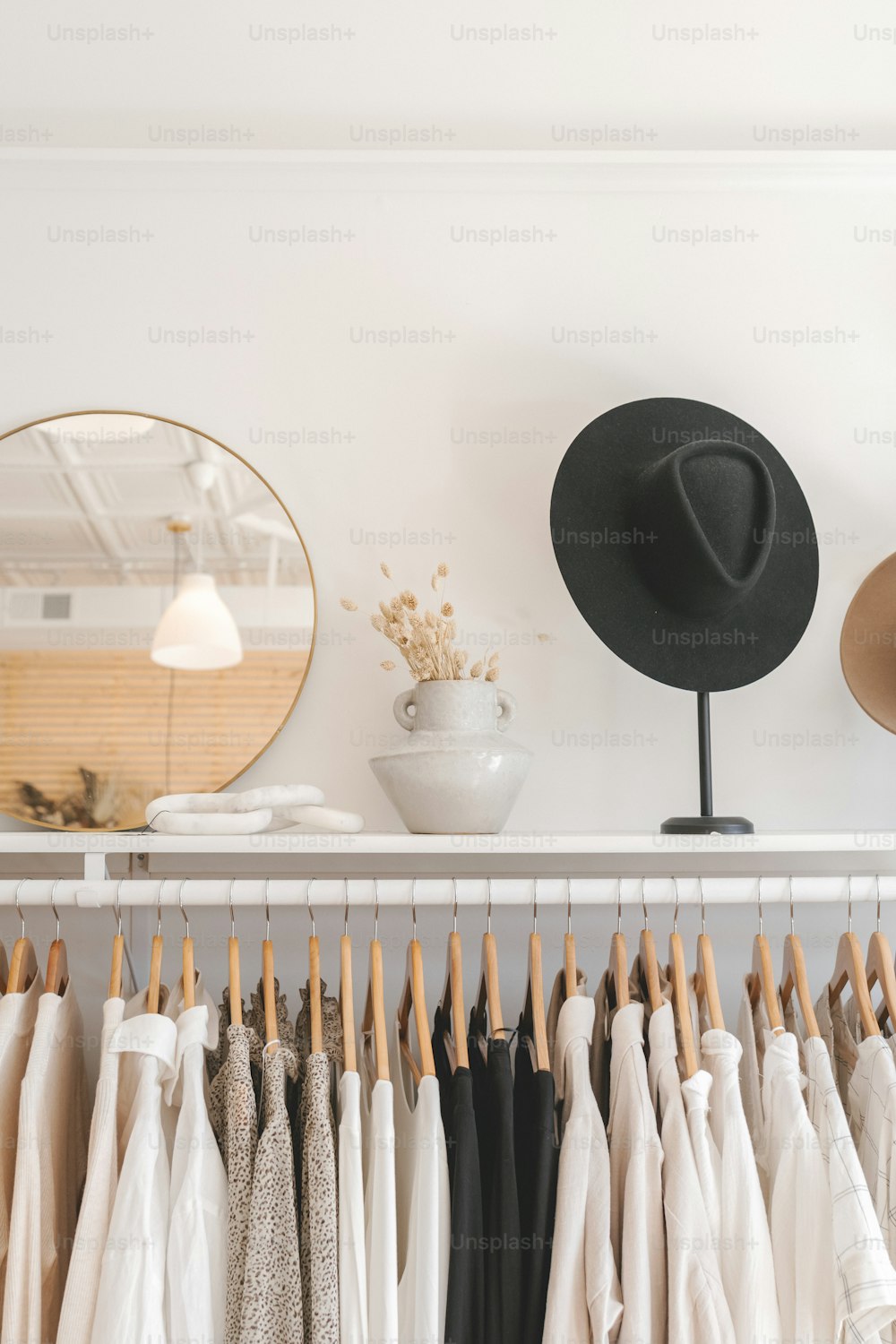 a hat is on a rack next to a mirror