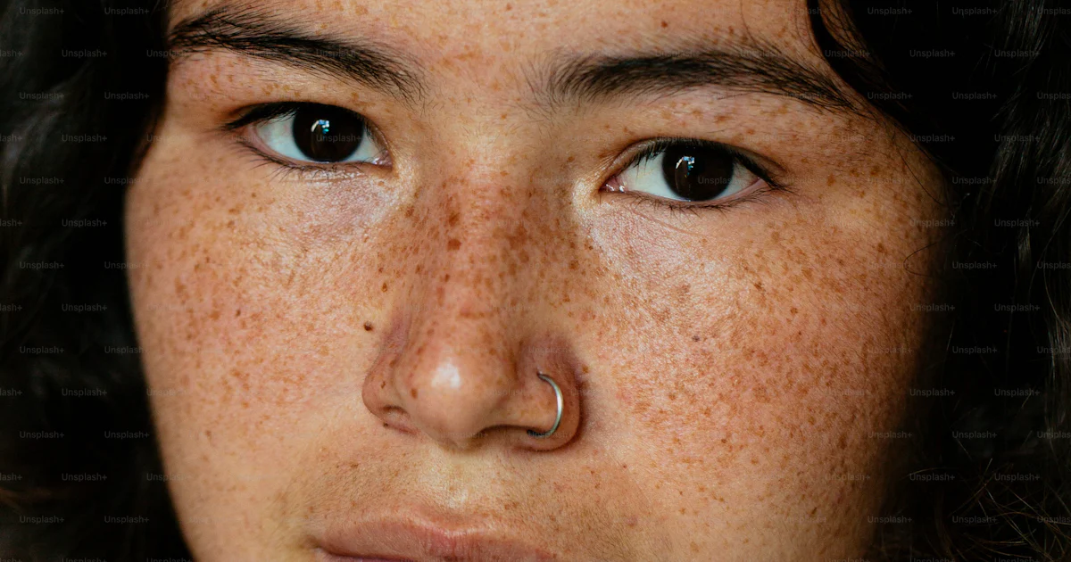 Frecking A close up of a person with freckles on her face photo – Female face ...