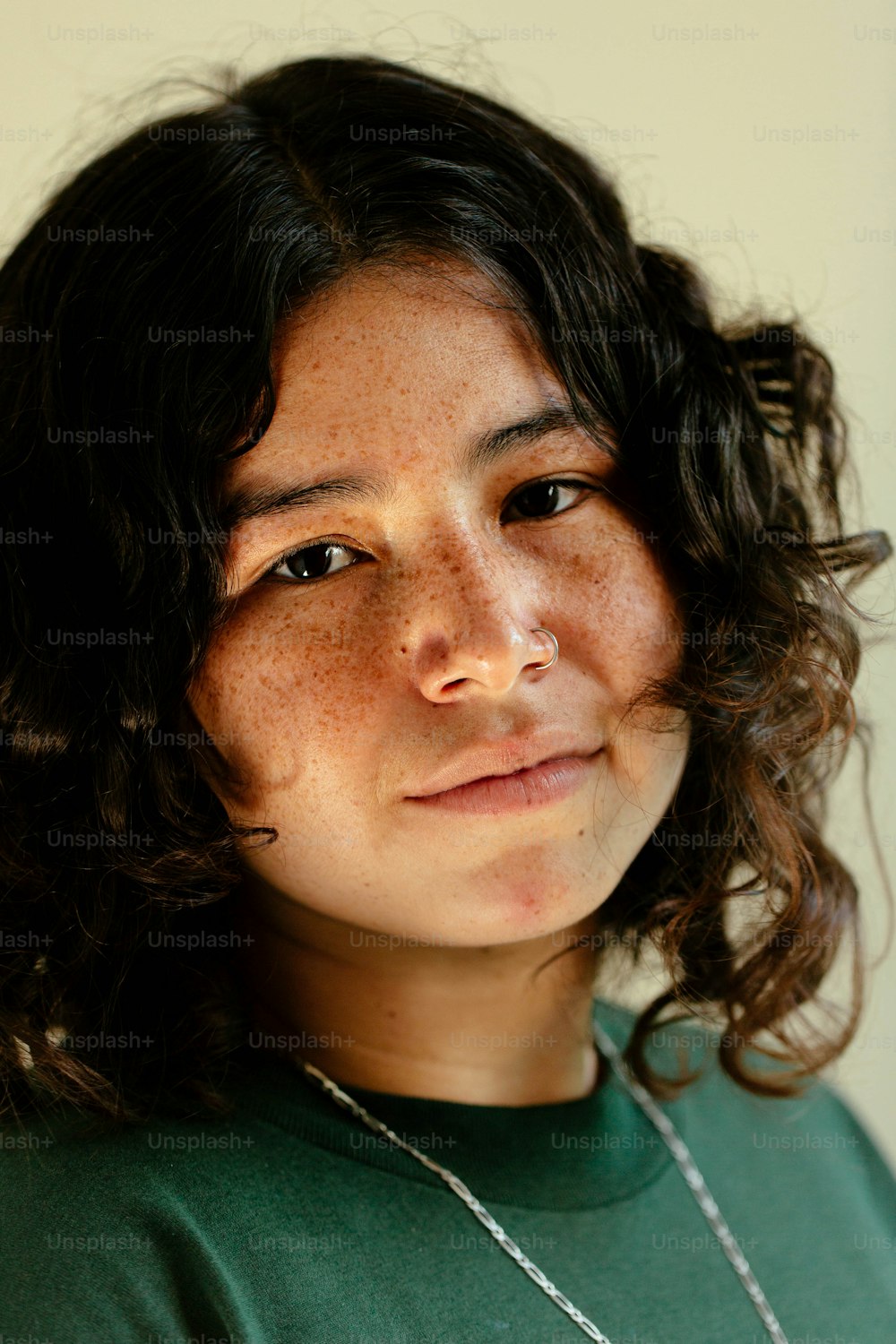 a close up of a person wearing a green shirt