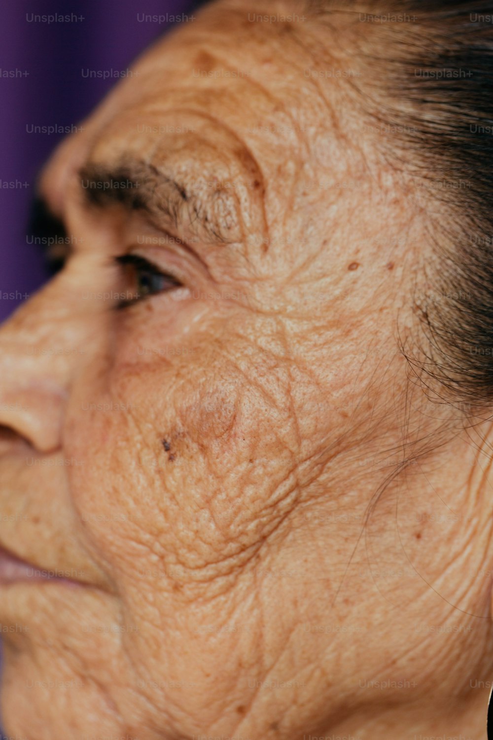 a close up of a woman's face with wrinkles