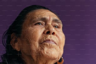 an old woman looking up with a purple background