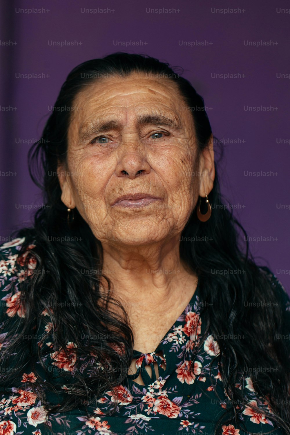 an old woman with long hair and earrings