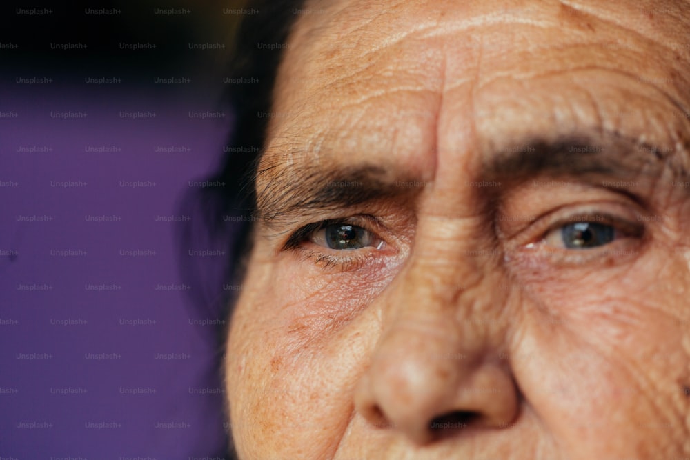a close up of a woman's face with wrinkles