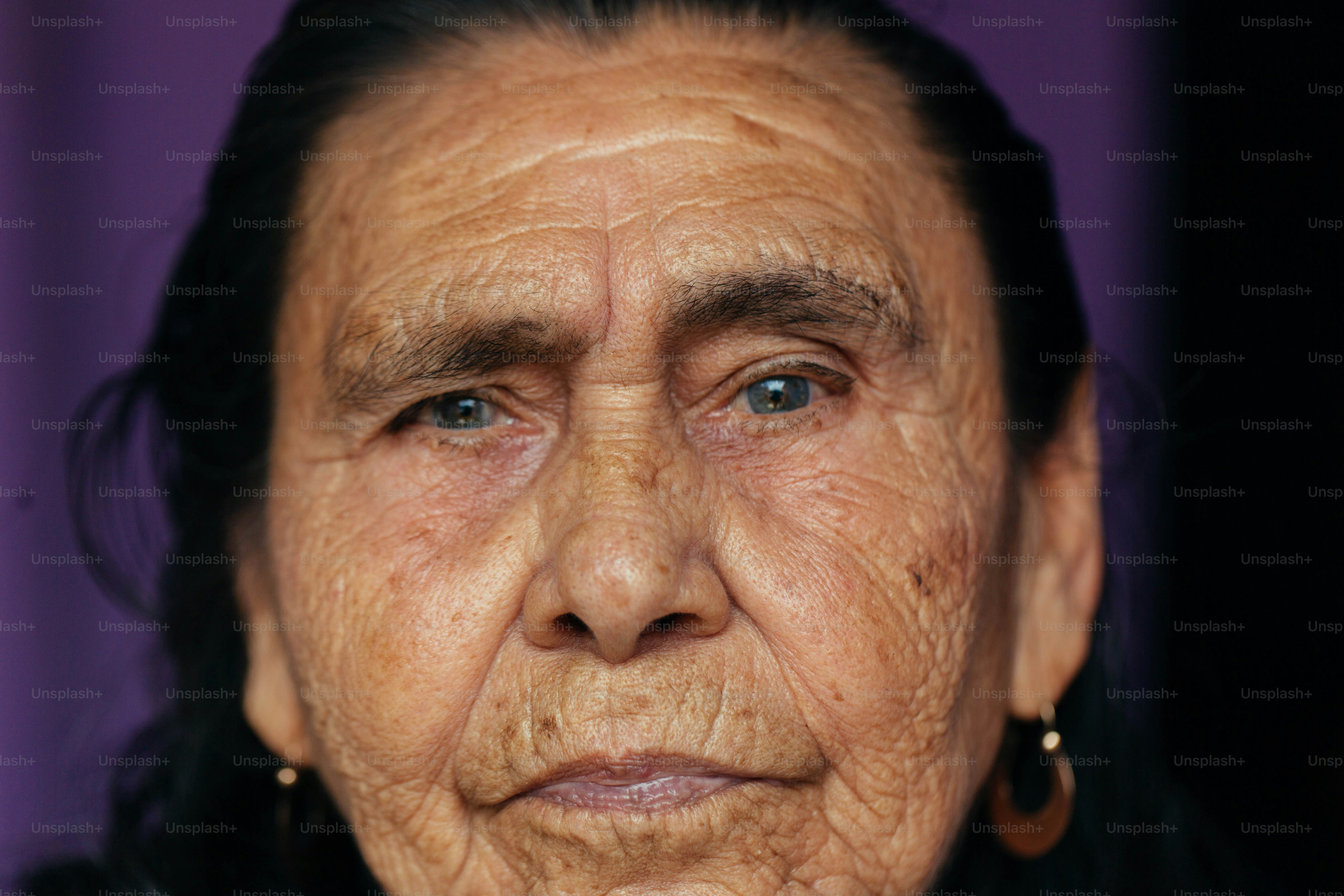 a close up of a woman's face with wrinkles