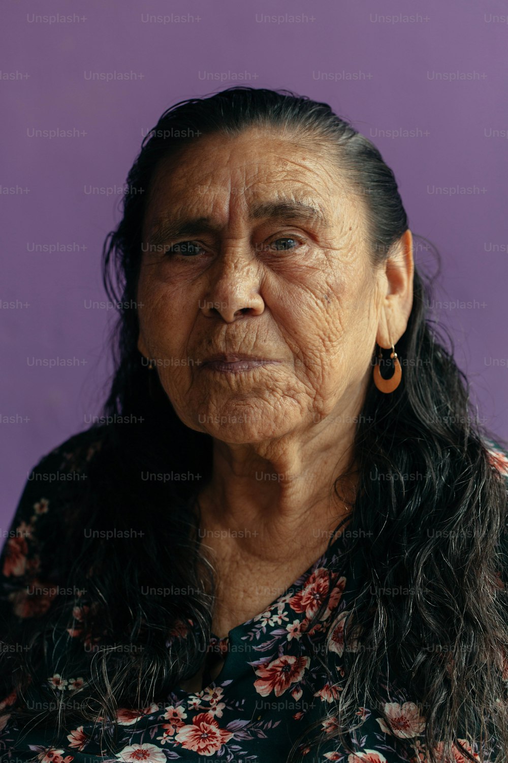 an old woman with long hair and earrings