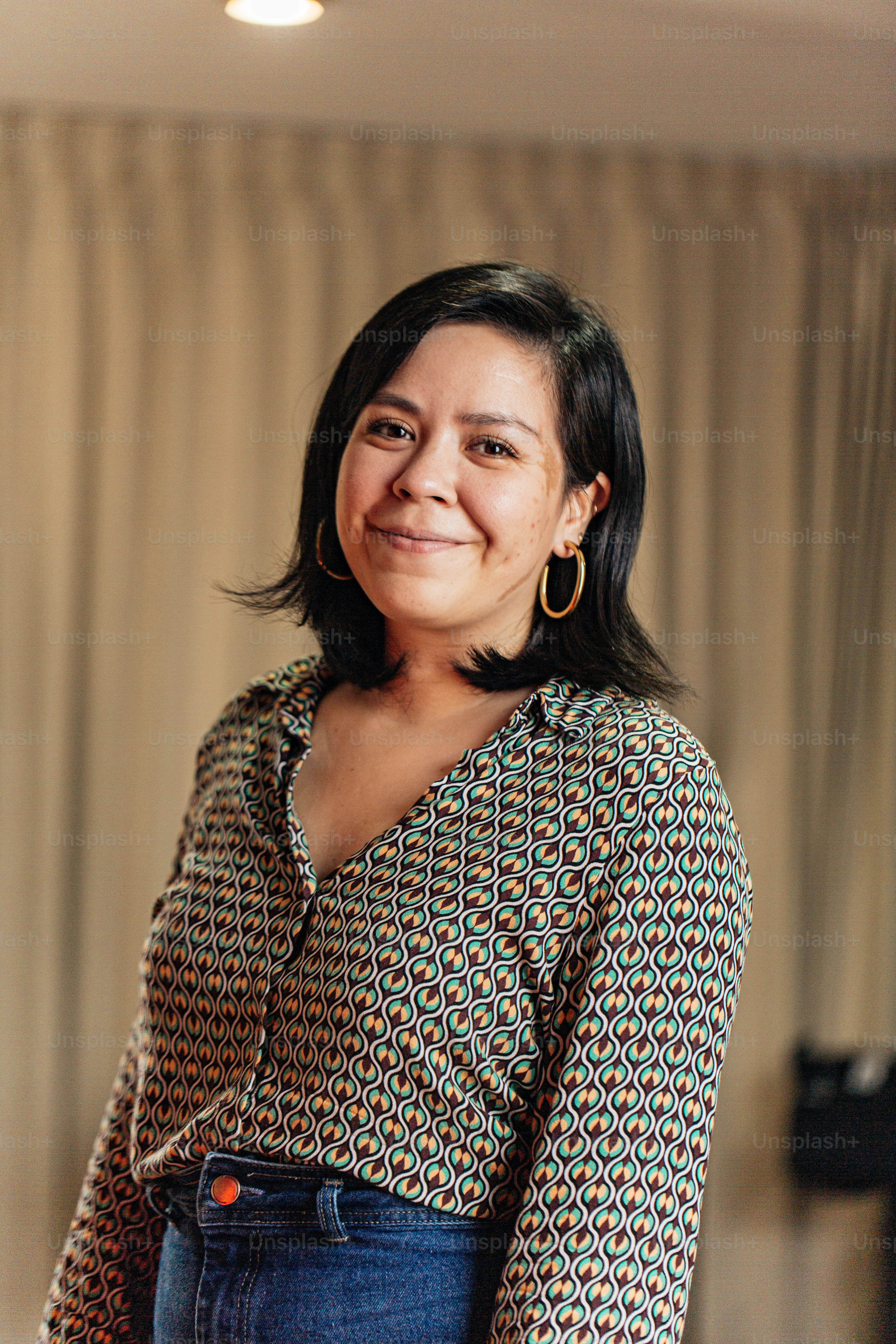 a woman standing in a room with a smile on her face
