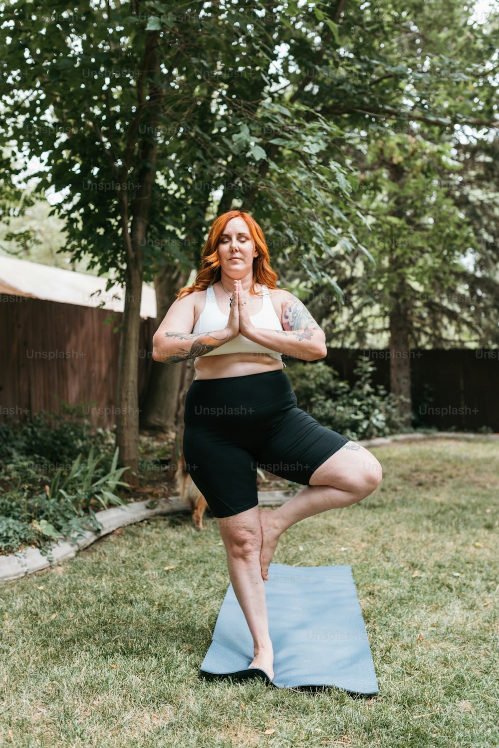 a woman in a yoga pose on a yoga mat