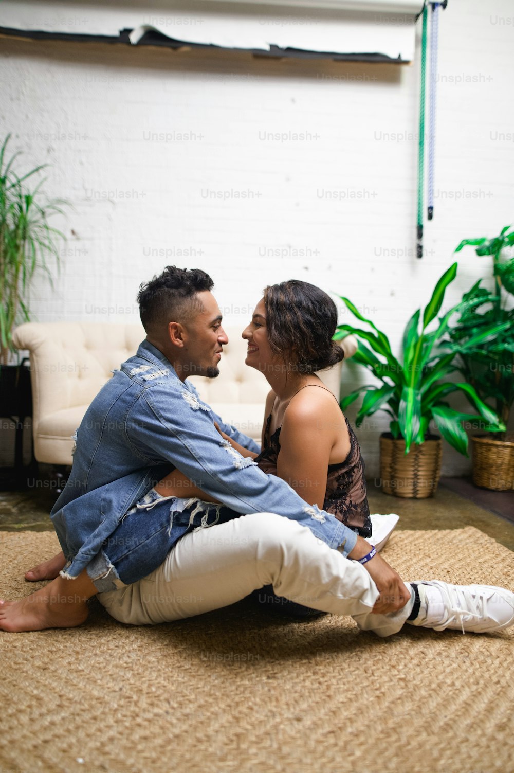 a man and a woman sitting on the floor