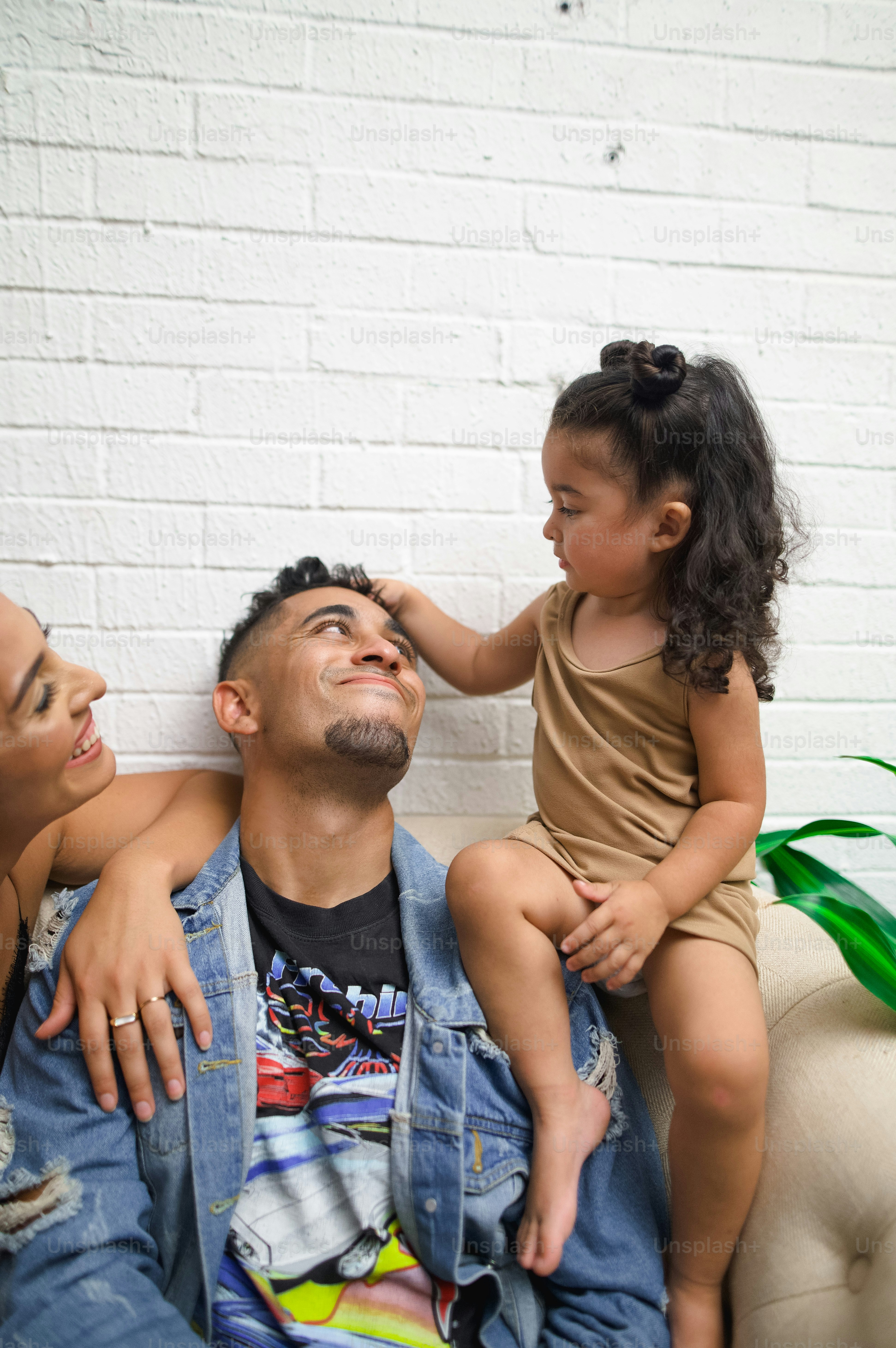 a man sitting on a couch with a little girl