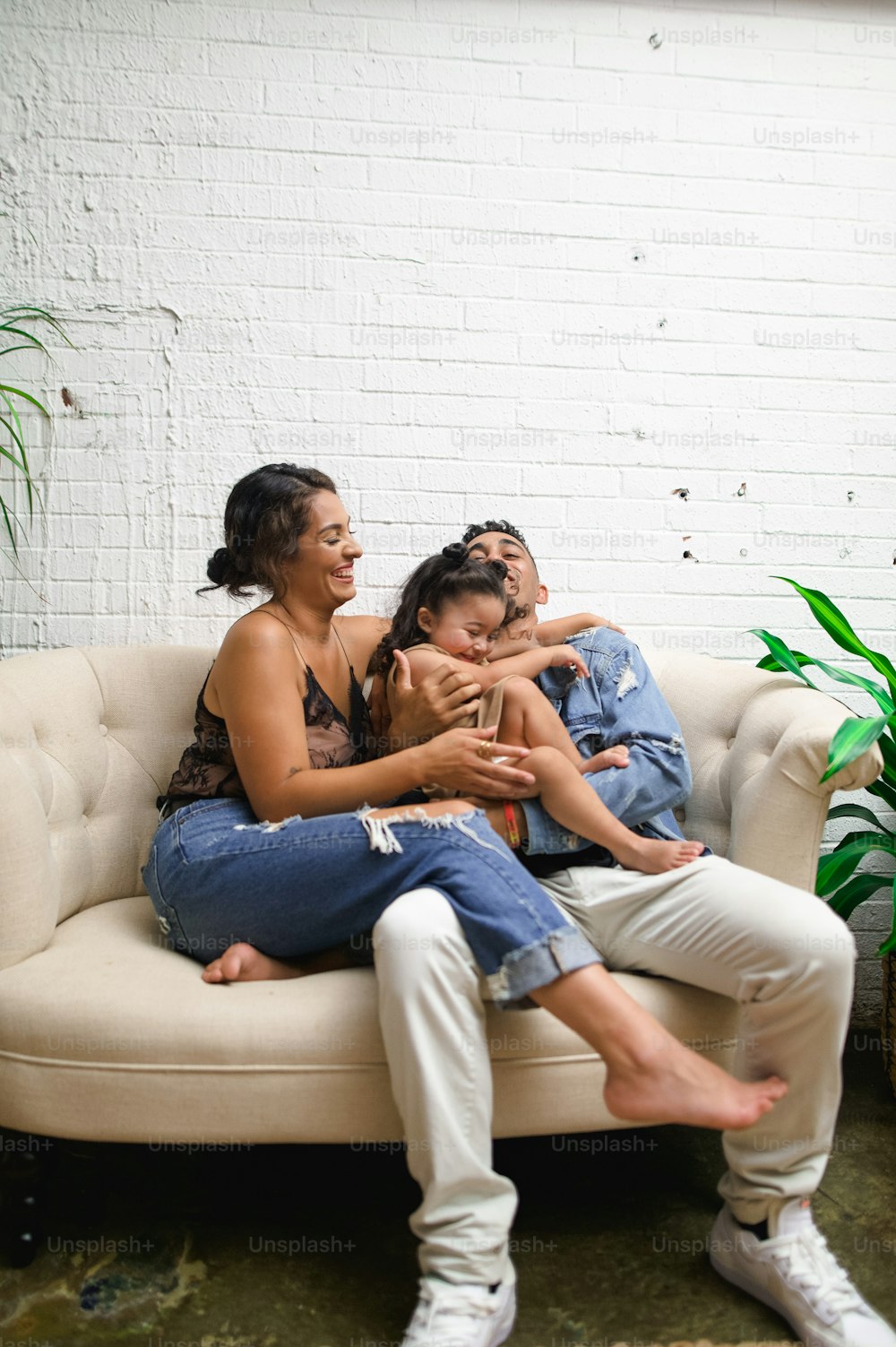 a woman and two children sitting on a couch