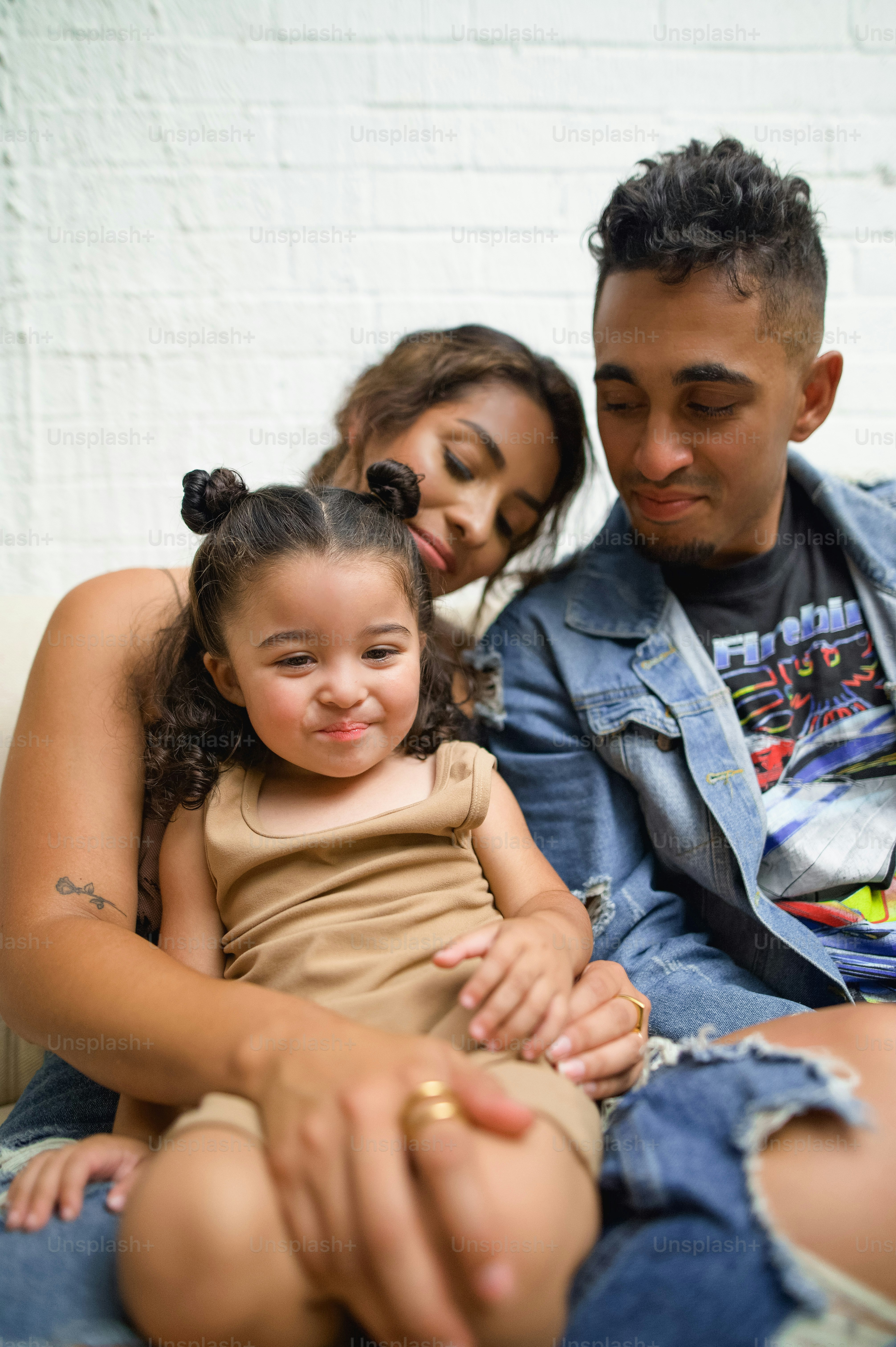 a man sitting next to a little girl on a couch