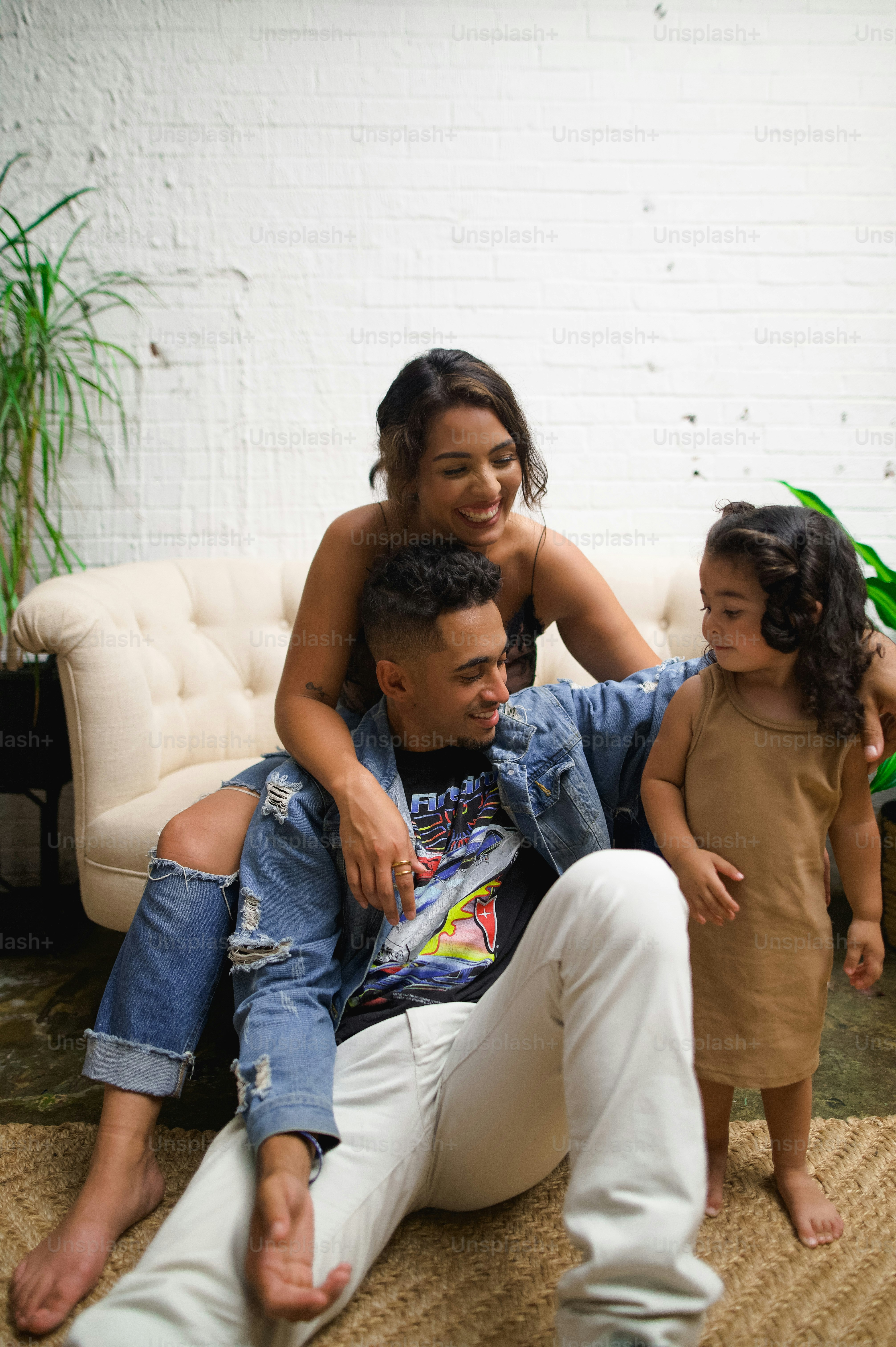 a man sitting on a couch with a little girl