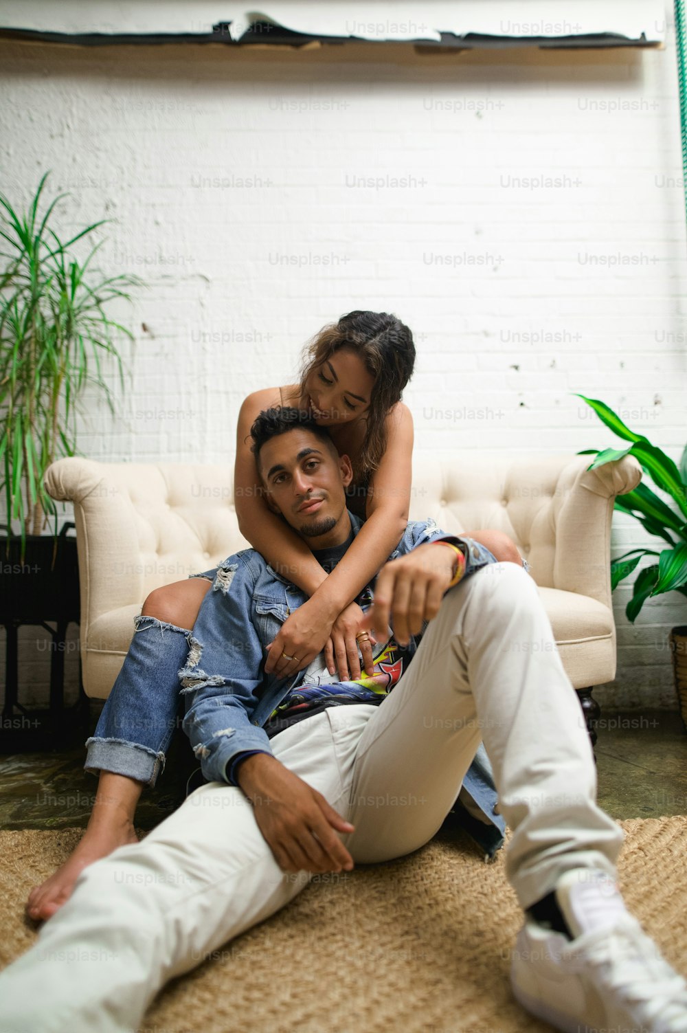 a man sitting on the floor holding a woman