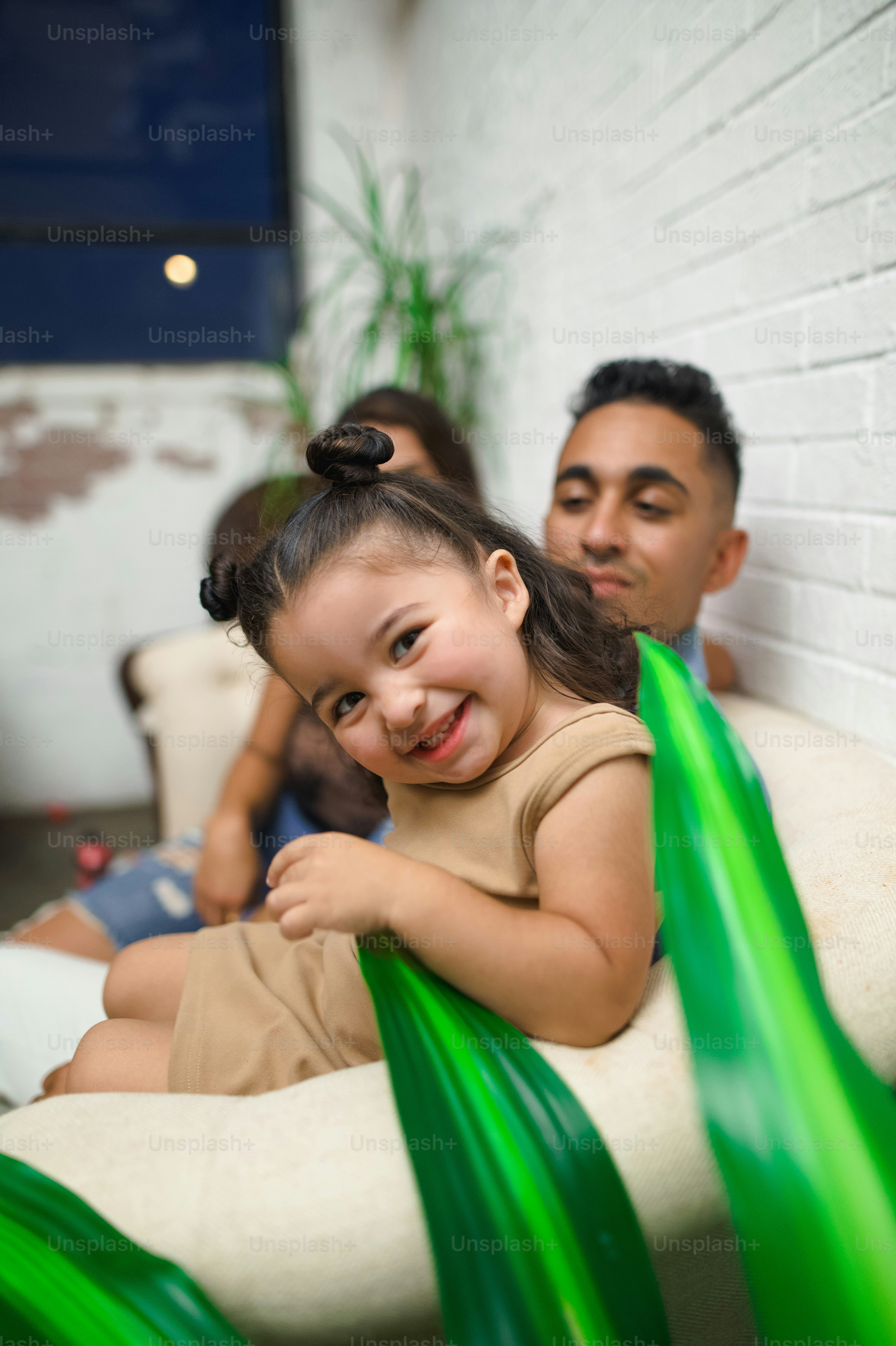 a little girl sitting on top of a white chair