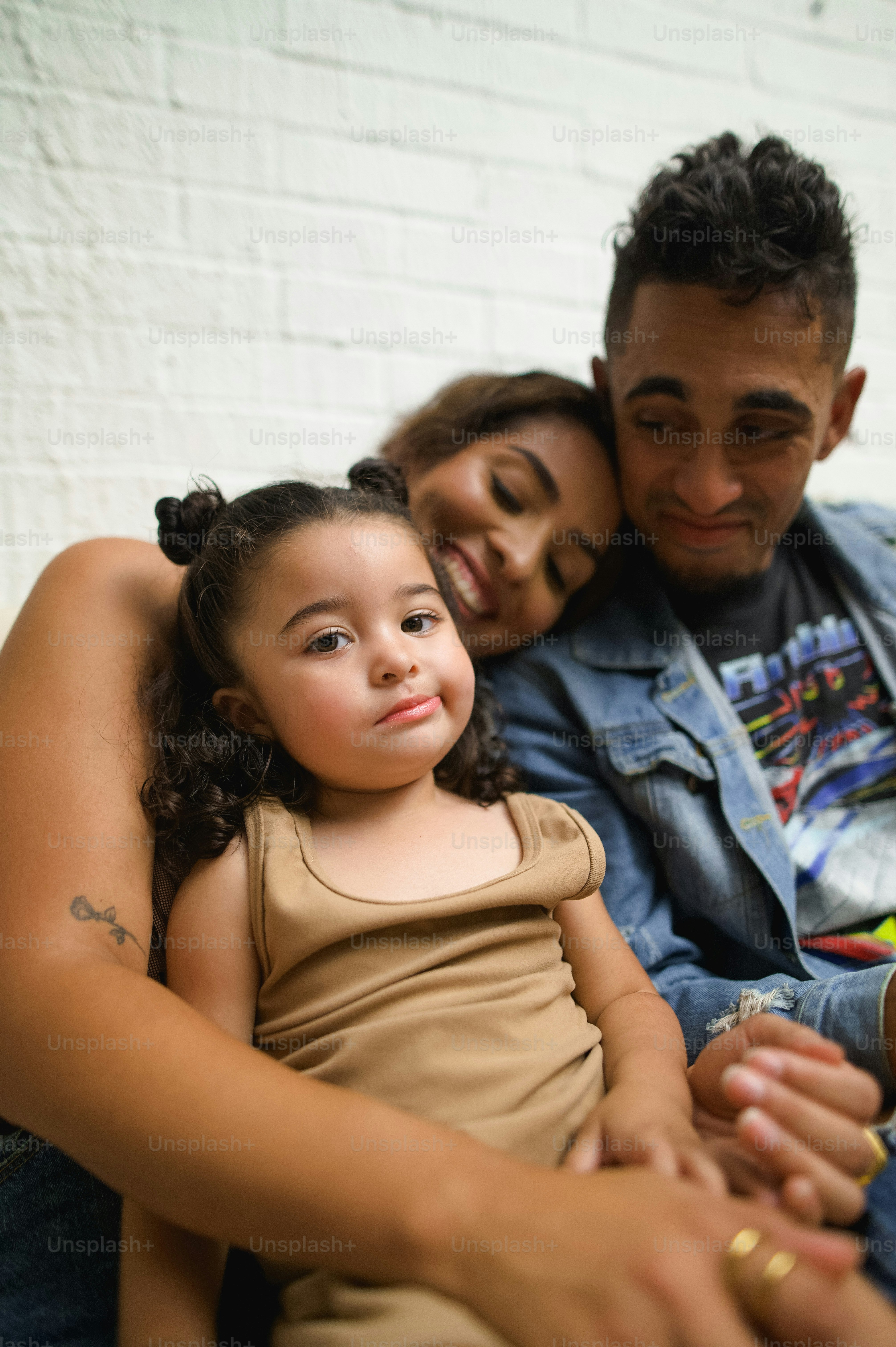 a man sitting next to a little girl on a couch