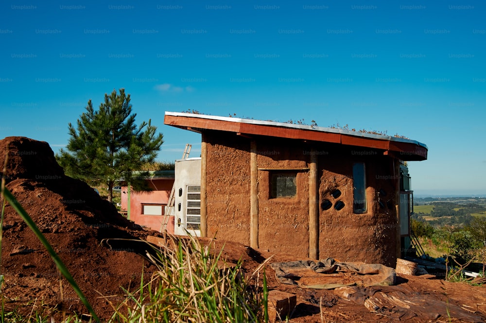 a small building sitting on top of a dirt hill