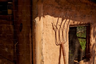 a pair of scissors hanging from the side of a building