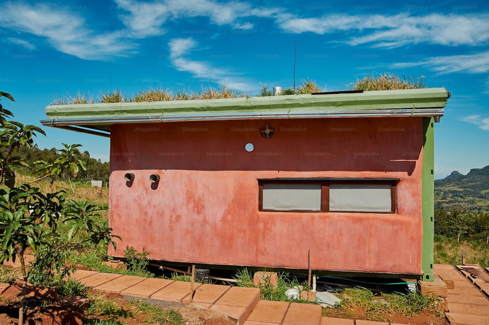 a red building with a green roof and a green roof