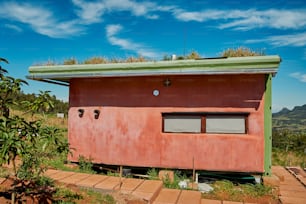 a red building with a green roof and a green roof