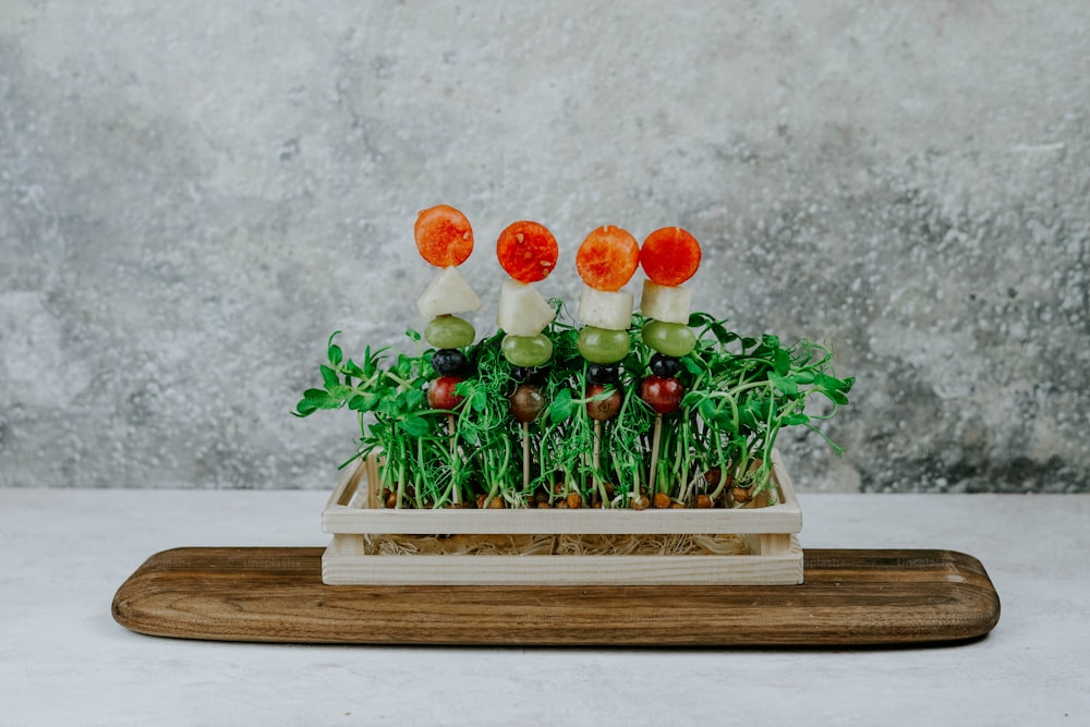 a wooden tray with vegetables on top of it