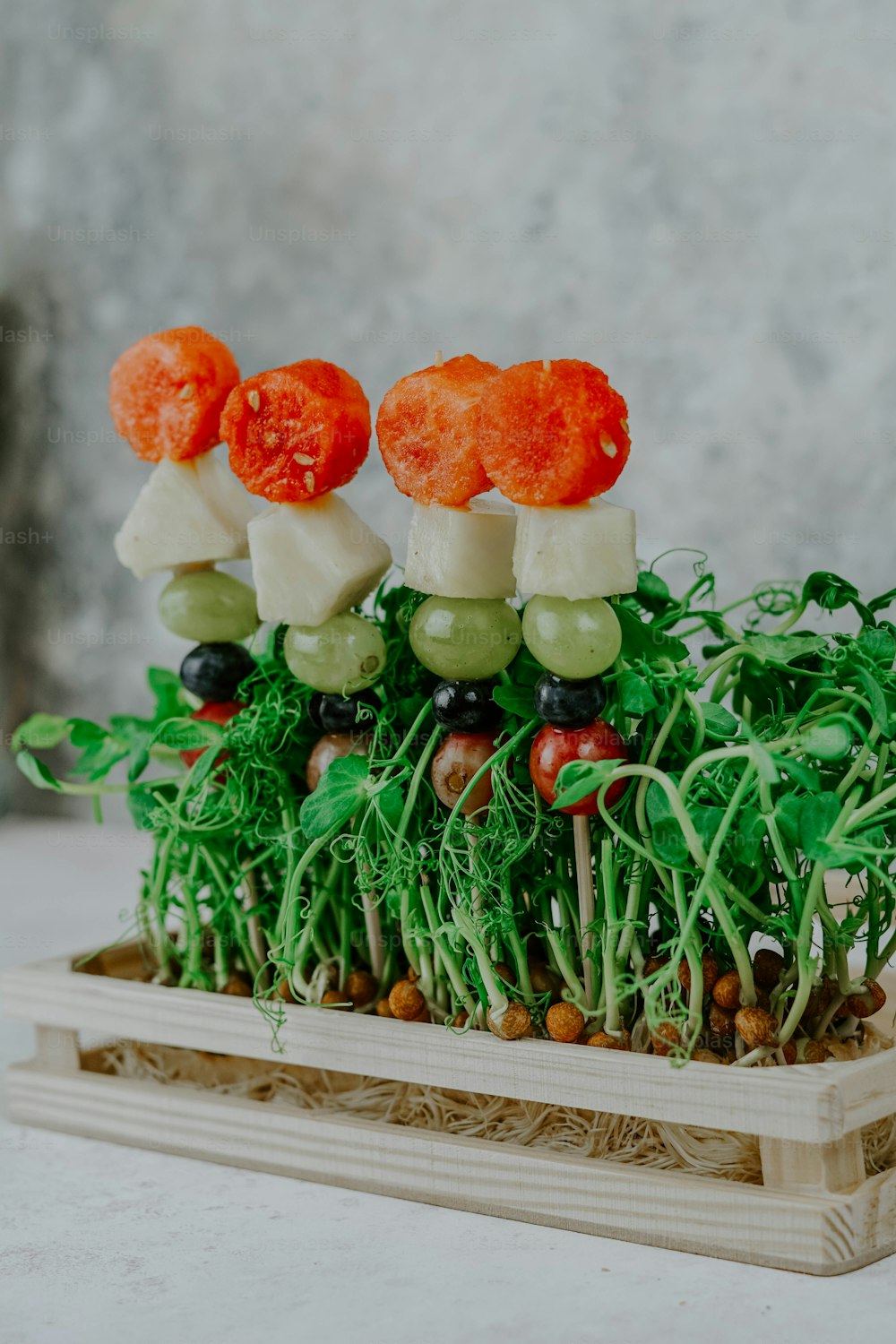 a group of vegetables sitting on top of a wooden tray