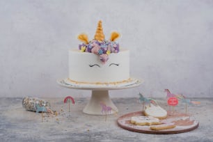 a white cake with a unicorn face on top of it