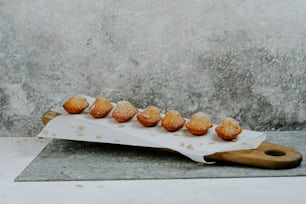 a bunch of doughnuts sitting on a cutting board