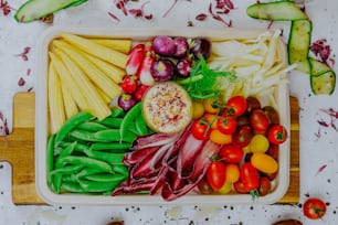 a variety of vegetables are arranged on a cutting board