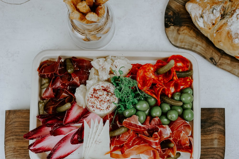 a platter of meats and cheeses on a table