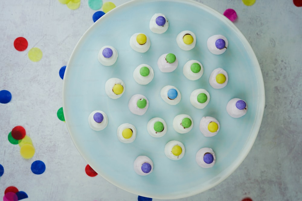 a blue plate topped with lots of white frosting