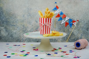 a table topped with a cake covered in french fries