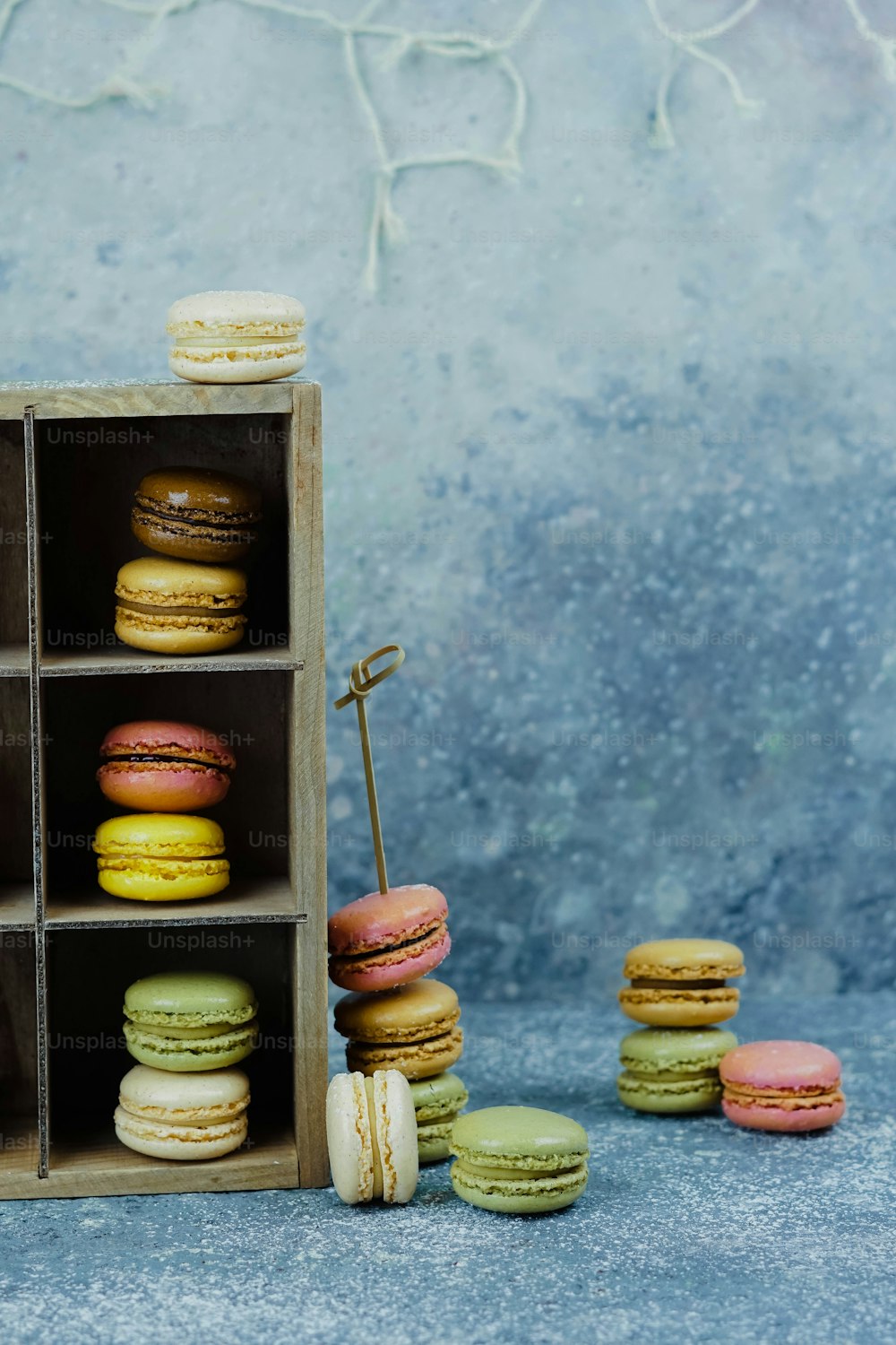 a wooden box filled with lots of different colored macaroons