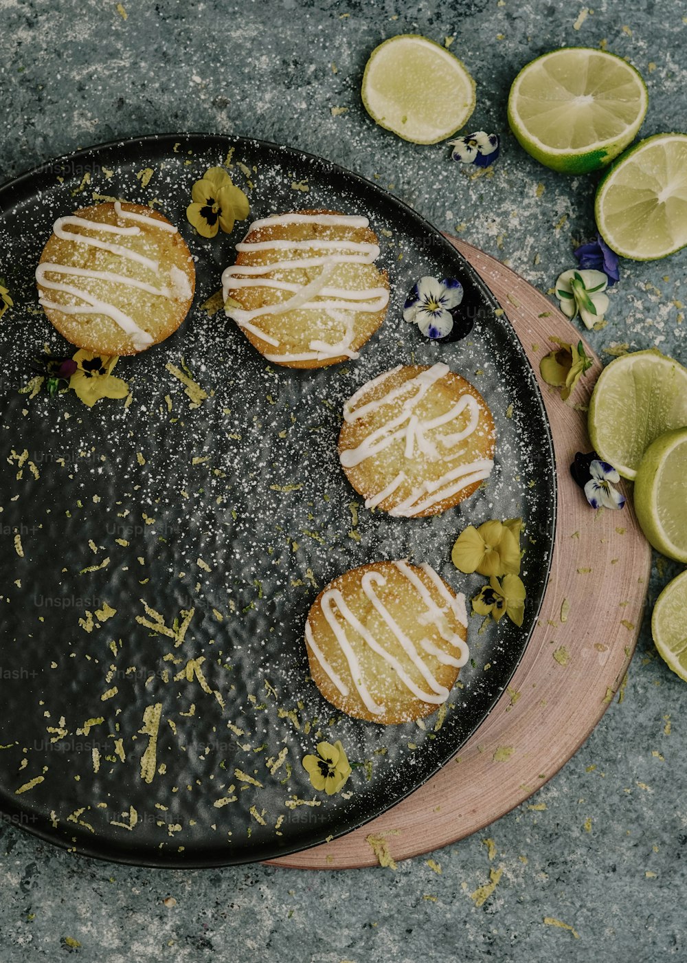 a plate with lemon cookies and limes on it