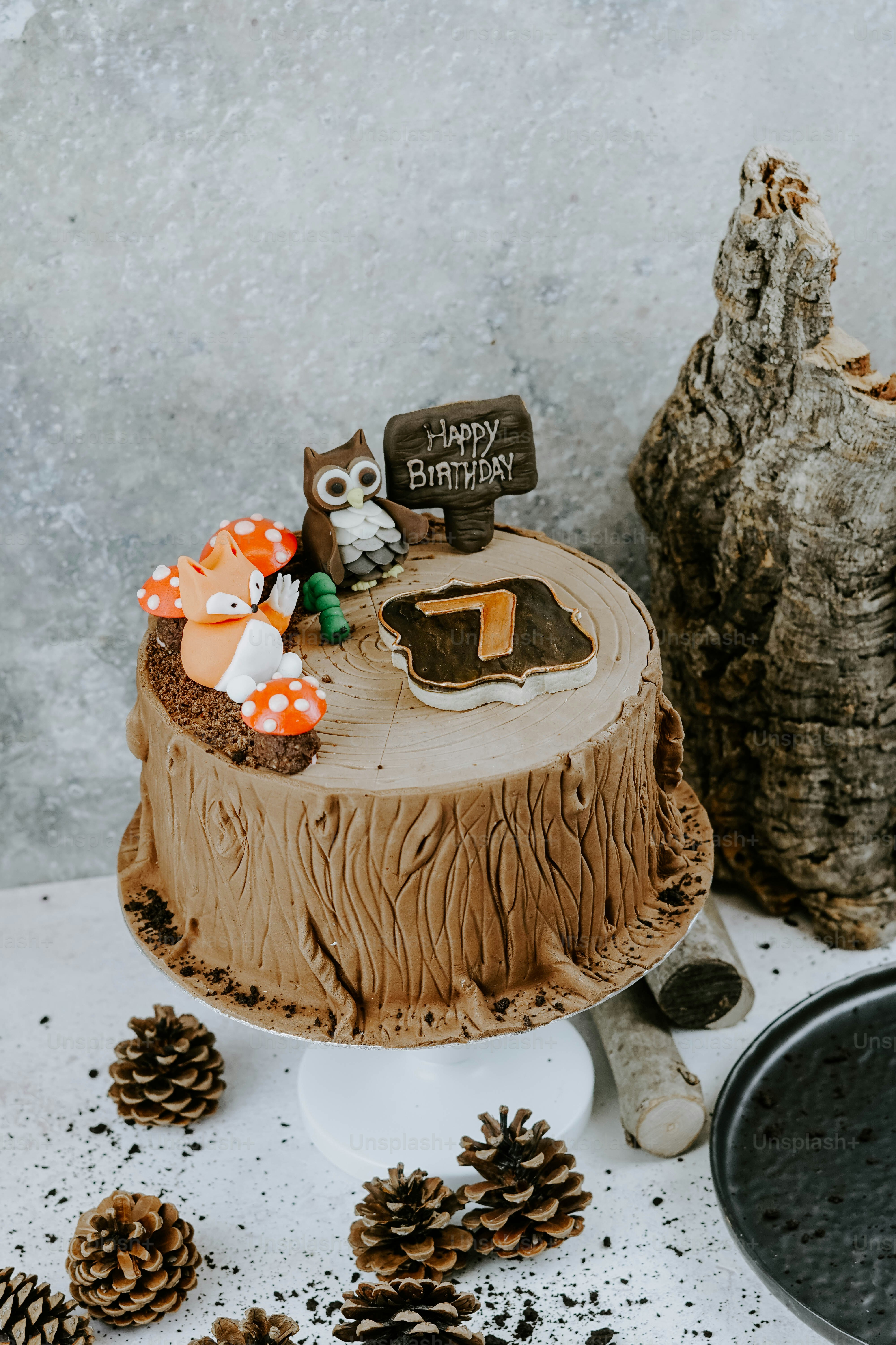 a birthday cake with an owl decoration on top of it