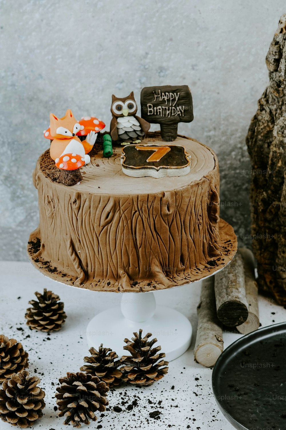a birthday cake with an owl decoration on top of it