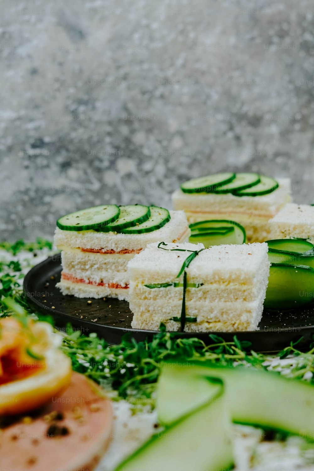 cucumber slices are arranged on a black plate