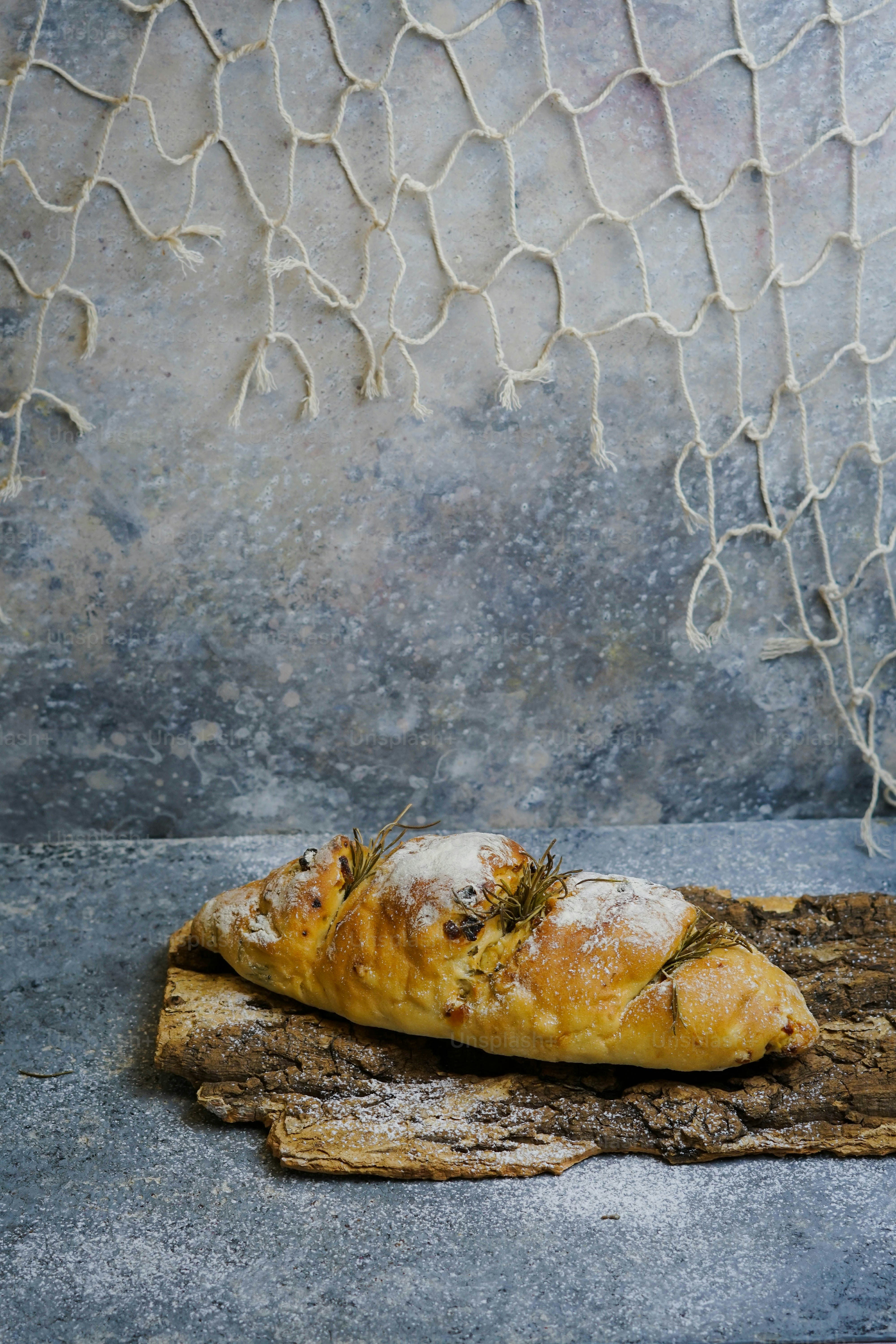 a piece of bread sitting on top of a piece of wood
