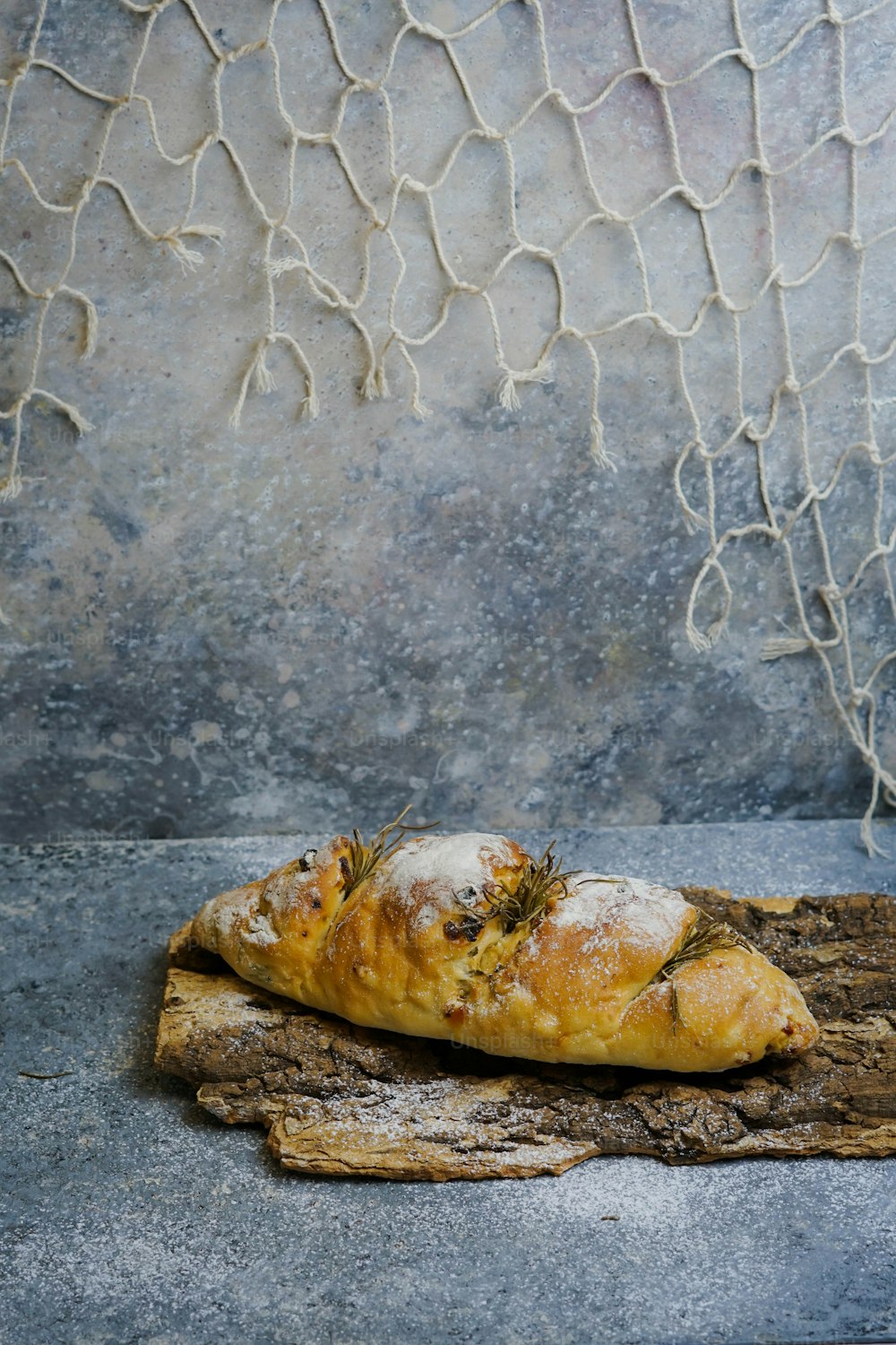 a piece of bread sitting on top of a piece of wood