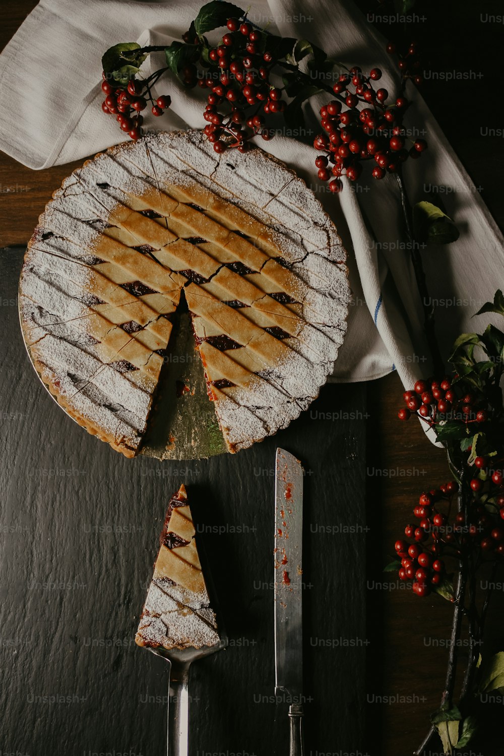 a pie sitting on top of a cutting board next to a knife