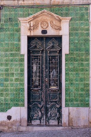 a green and white building with a black door